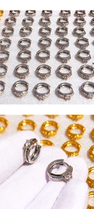 Detail view of twist-textured huggie hoop earrings with square cubic zirconia setting