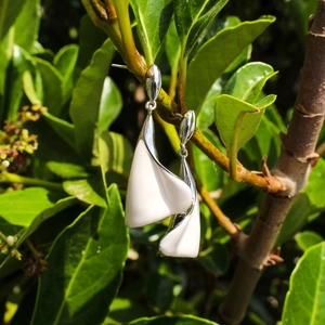 Elegant white enamel calla lily earrings in abstract leaf design with silver polish finish