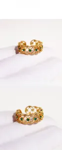 Detail of vintage gold open ring featuring green zircon and intricate lace openwork
