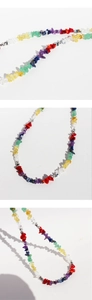 Detailed close-up of handmade colorful natural stone chip necklace with metal beads