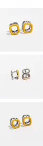 Detail presentation showing silver square hoop earrings with vibrant orange enamel finish