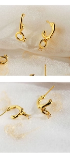 Detail view of gold C-shape irregular earrings with sparkling zircon drop accents