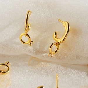Minimalist C-shaped gold earrings featuring sparkling zircon stone accents for women