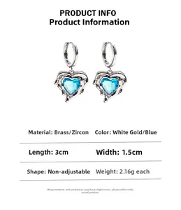 Detail of silver-tone liquid lava heart earrings featuring 3cm blue zircon stones