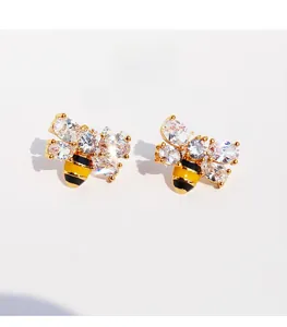 Detailed view of handmade enamel bee earrings with sparkling zircons and gold plating