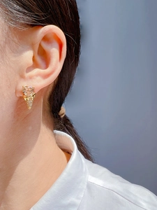 Close-up of creative ice cream stud earring with heart champagne zircon and pavé crystals