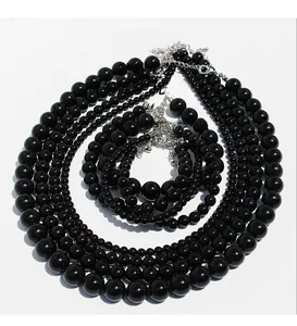 Macro view of multi-layer black onyx beaded necklace with silver lobster clasp and extension