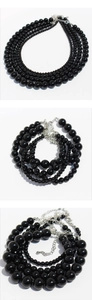 Detailed view of multilayer black onyx beads with silver lobster clasp and extension chain