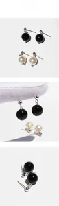 Detail view of black onyx and white pearl stud earring set with polished silver pins
