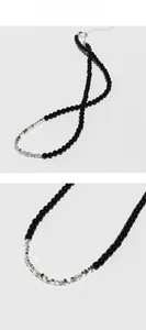 Detail showing black onyx beads and irregular silver pieces with lobster clasp closure