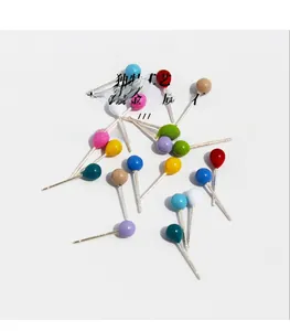 Detailed macro view of colorful enamel ball stud earrings with gold plating and zircon
