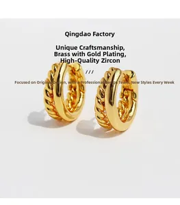 Macro shot of gold-plated twisted rope earrings featuring high-quality cubic zirconia