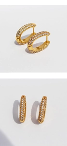 Macro detail of gold-plated U-shape hoop earrings with micro-pave cubic zirconia stones