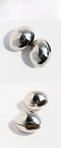 Detailed view of large oval silver earrings with a high-polish mirror finish surface