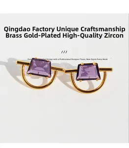 Detail of gold plated brass earrings featuring rectangular purple zircon stones