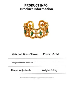 Detail of vintage brass ring with emerald zircon, 1cm width and adjustable lace pattern
