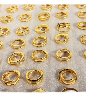 Macro shot of gold-plated geometric interlocking rings with sparkling zircon inlay