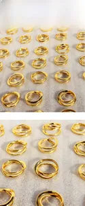 Close-up of double-layered wavy gold ring with irregular geometric crossing lines