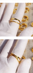Close-up of gold geometric double-layered and twisted rings with polished metallic finish