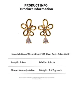 Detail of gold flower earrings with teardrop zircon drop and 925 silver needles