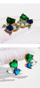 Detail of cluster heart stud earrings featuring navy blue, forest green, and light blue zircons