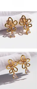 Detail of gold floral drop earrings featuring pear-cut zircon and hollow petal design