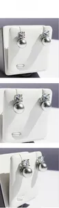 Macro detail of S925 silver stud earrings with grey round pearls and bright cubic zirconia