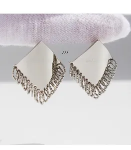 Detail of silver rhombic tassel earrings made of brass gold plating and premium zircon