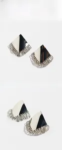 Detail of silver geometric fringe earrings with polished triangle and multi-ring chains