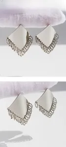 Detail shot of silver geometric diamond stud with multi-layered circular fringe tassels