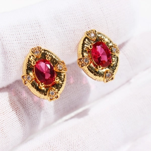 Vintage gold oval stud earrings with red zircon gemstone and relief texture for women
