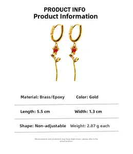 Detail view of 18K gold plated brass U-shape earrings with red enamel rose pendant