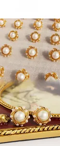 Detailed view of French vintage gold twist earrings with large white pearls and tiny beads
