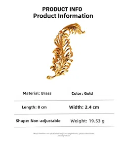 Macro detail of golden feather brooch showing 8cm length and polished brass texture