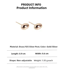 Detail view of oval metal stud earrings showing dimensions of 0.9cm length and brass material