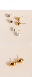 Macro shot of minimalist metallic bean earrings with polished mirror finish in gold and silver
