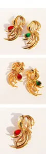 Macro shot of gold phoenix brooch detail showing back pin structure and droplet gemstones