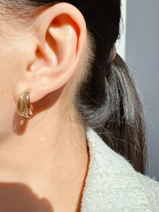Detailed view of gold plated layered C-hoop earrings featuring a twisted rope texture