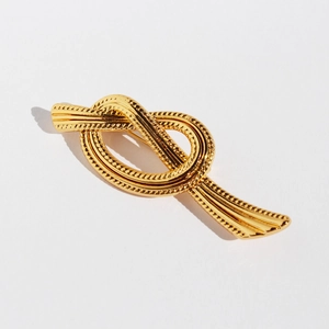 Golden ribbon knot brooch in brass with woven textures for vintage suit styling