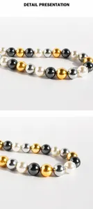 Dettaglio ravvicinato della collana di perle multicolore in oro, argento e grigio