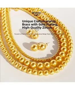 Detail of gold-plated brass necklace and stud earrings set with premium cubic zirconia