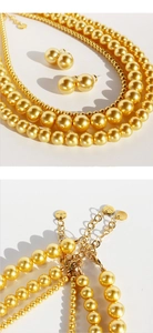 Detail view of gold pearl necklace set with lobster clasp and extension chain
