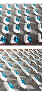 Macro view showing white enamel square earrings with emerald-cut blue cubic zirconia