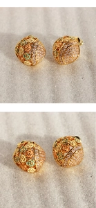 Macro shot of hollow enamel flower earrings with sparkling cubic zirconia detailing
