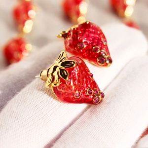 Artistic red enamel strawberry earrings with gold leaves and purple rhinestones