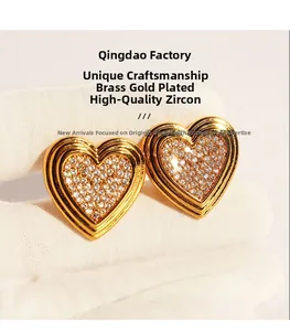 Detail of gold-plated heart earrings featuring micro-set cubic zirconia crystals