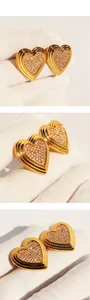 Macro detail of gold heart earrings with micro-set zircons and three-tier grooved edges