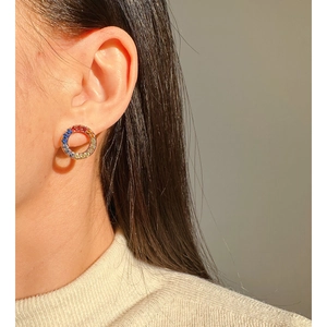 Rainbow zircon circle earrings featured on a model with warm natural light highlights
