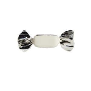 Silver candy-shaped brooch with white enamel detail and mirror-like metallic finish