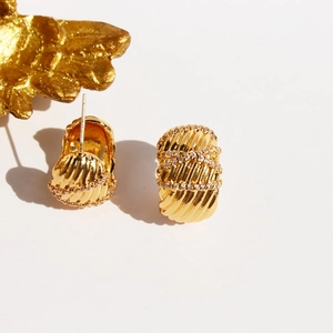Golden wide wave earrings in brass with twisted patterns and white diamonds